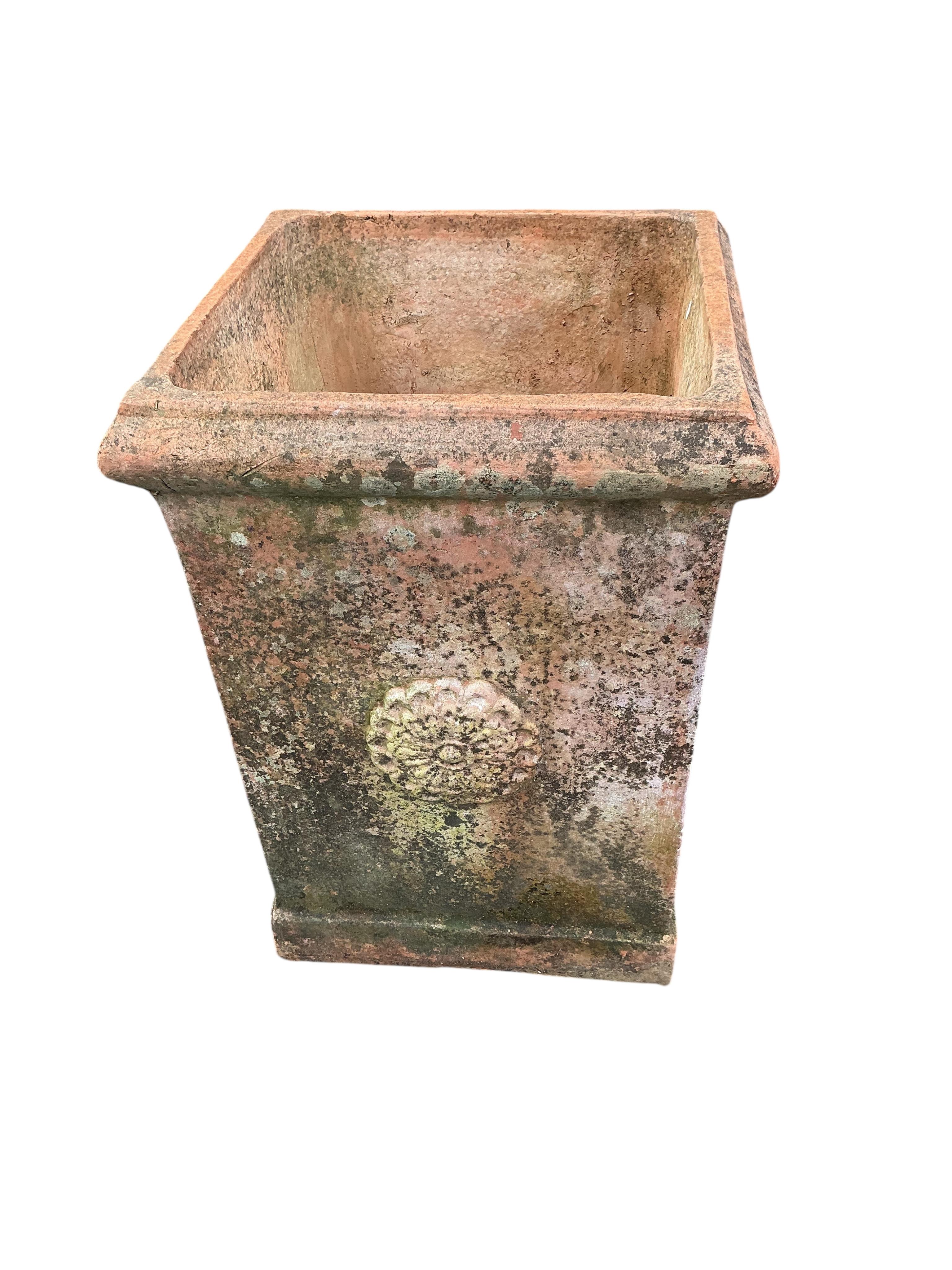 A large square terracotta garden planter, width 46cm, height 64cm